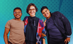 Three smiling young people posing together against a teal graphic background.
