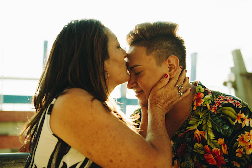 LGBTQ+ teen daughter happily embracing and receiving acceptance from her mother after coming out