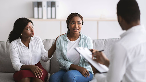 Young black lesbian couple speaking to a mental health professional