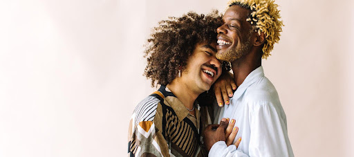 diverse lgbtq couple smiling and embracing